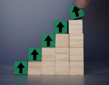 picture showing growth through accelerating stairs with upward arrows on each