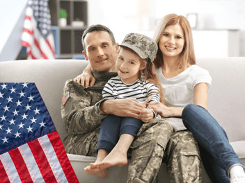 a veteran's family with baby wearing army hat 