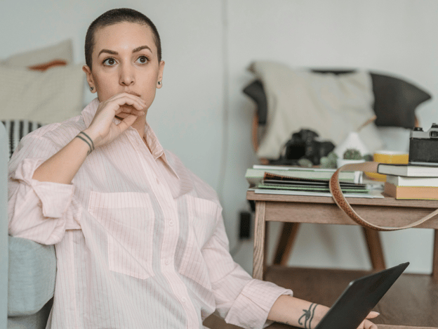 conclusion: woman thinking with laptop on a table